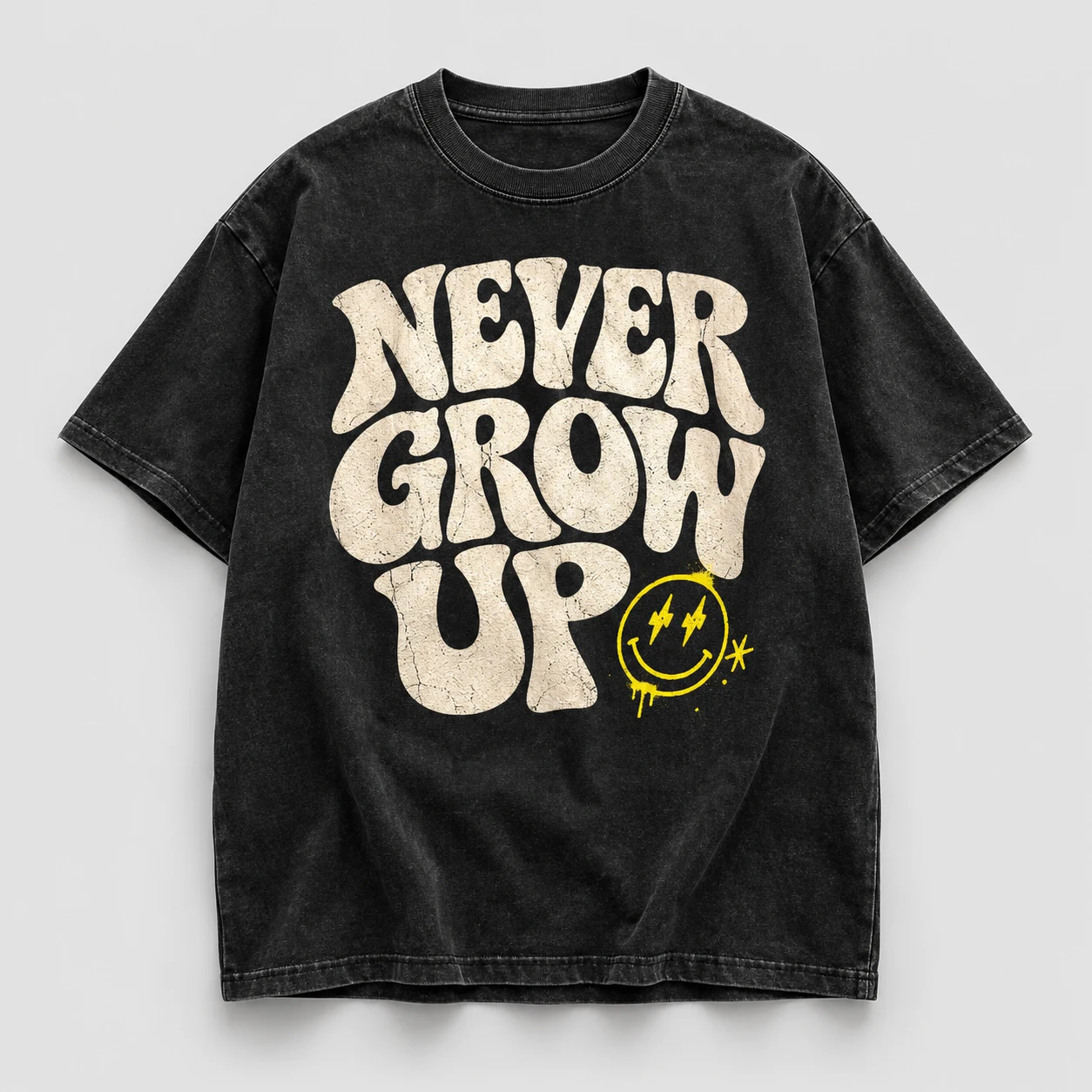 Never Grow Up graphic on a washed black T-shirt