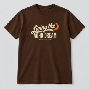 Living The ADHD Dream Tee in chocolate brown with a compact chest print — concept mockup