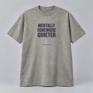 Mentally Somewhere Quieter Tee in stone grey with a compact chest print — concept mockup