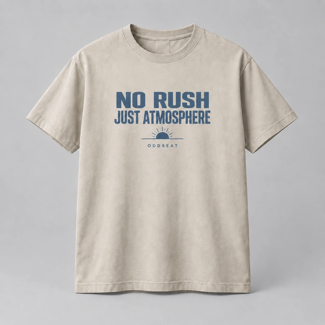 No Rush Just Atmosphere Tee in stone with a compact chest print — concept mockup