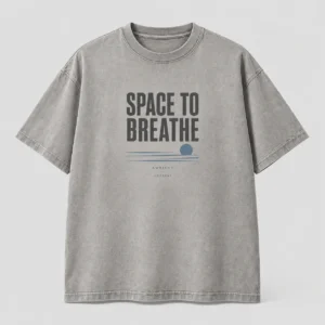 Space to Breathe Ambient Tee in stone grey / blue with a compact chest print — concept mockup