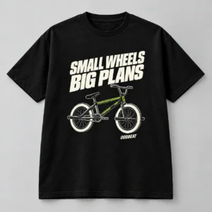 Small Wheels Big Plans Tee in black with a compact chest print — concept mockup