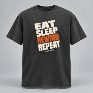 Eat Sleep Rewind Repeat Tee in charcoal with a compact chest print — concept mockup