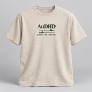 AuDHD Different Settings Tee in Oat / Forest — compact graphic concept mockup