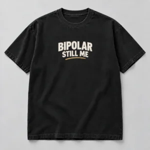 Bipolar Still Me Tee in Washed Black / Cream — compact graphic concept mockup