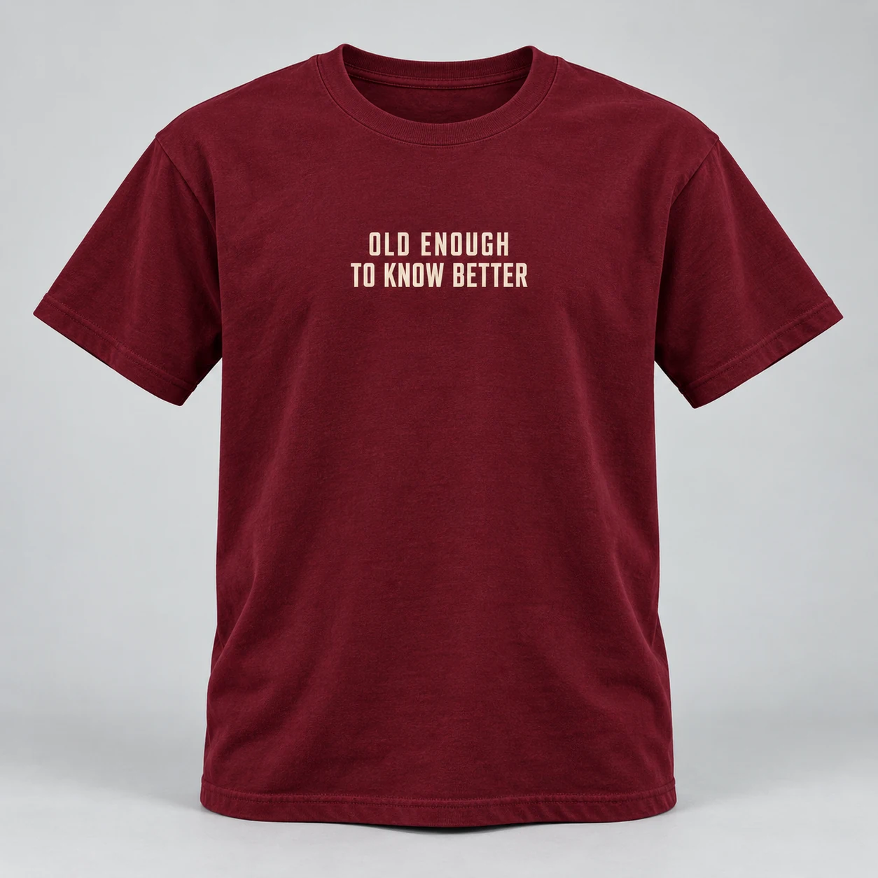 Old Enough To Know Better Tee in Burgundy / Cream — compact graphic concept mockup