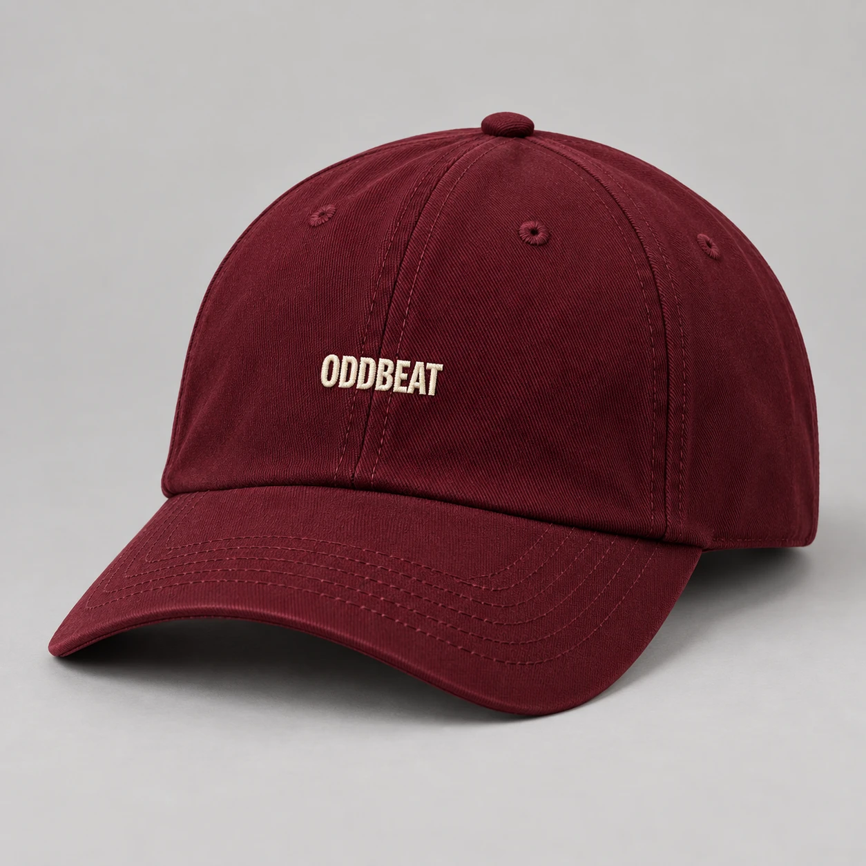 Micro Logo Cap — Burgundy in Burgundy / Cream with micro Oddbeat logo — concept mockup