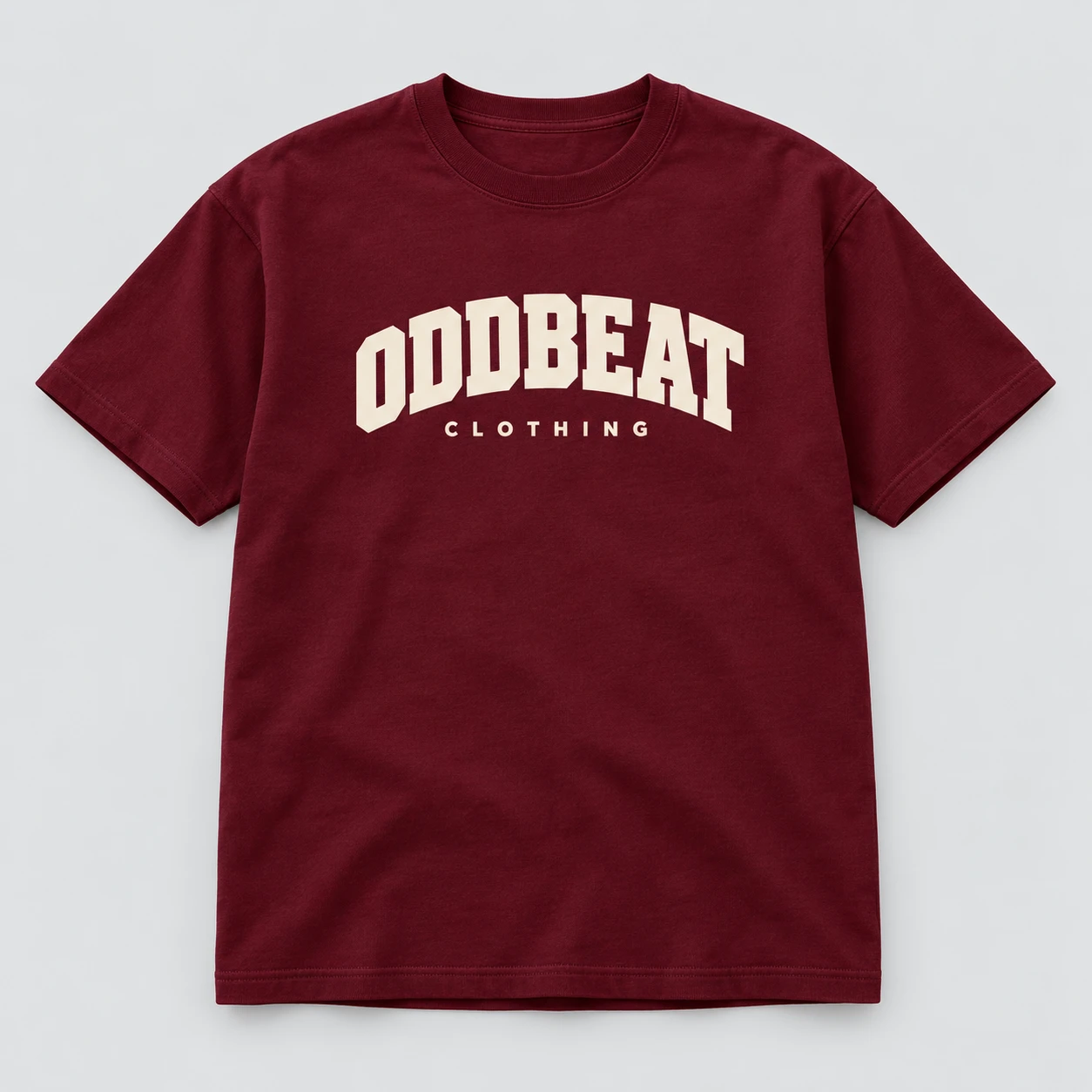 Varsity Tee — Burgundy in Burgundy / Cream with varsity Oddbeat logo — concept mockup